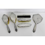 A Birmingham silver backed six piece dressing table brush set comprising hand mirror, two hair