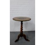 A circular inlaid side table with brass edge on a barley twist stem and tripod support with brass