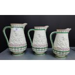A group of three Victorian Copeland white glazed and floral moulded jugs of graduated size,