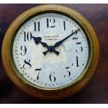 An oak framed wall clock, the dial marked Brook & Sons, Edinburgh, with Arabic numerals, 34cm