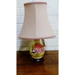 A Moorcroft table lamp base tubeline decorated with pink flowers to a cream ground