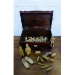 A mahogany box containing a collection of African carved wood figures and animals (a lot)