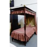 A contemporary mahogany framed single four poster bed complete with red chequered pelmets, pillows