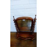 A Victorian mahogany dressing mirror, the rectangular dome topped plate on barley twist supports and