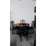 A 19th century dining set comprising a set of four Chippendale style splat back chairs and a