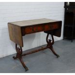 A mahogany sofa table with two short drawers on lyre end and reeded supports terminating in hairy