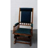 A mahogany framed rocking chair with padded back, seat and arms, 106 x 55cm