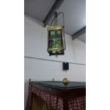 A brass and coloured glass panelled hanging lantern light fitting