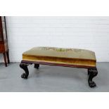 A Victorian mahogany framed long stool with a tapestry upholstered top on boldly carved cabriole