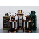 A collection of five metal and glass storm lanterns (5)