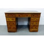 A Victorian mahogany twin pedestal desk, with an arrangement of nine drawers on plinth base and