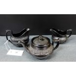 Black basalt ware to include two milk jugs and a small teapot, tallest 9cm (3)