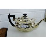 An Edwardian half gadrooned silver teapot with ebonised handle by George Nathan and Ridley Hayes,