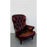 A leather button back armchair, 102 x 86cm