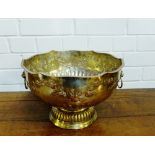 A large silver plate on copper punch bowl with twin lion mask handles to side on circular