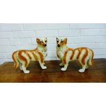 A pair of Staffordshire dogs, modelled standing, 28cm high (2)