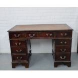 A mahogany pedestal desk, the rectangular top with a brown inset leather skiver over an