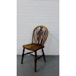 A country wood spindle back chair with pierced splat, solid seat, turned supports and stretcher