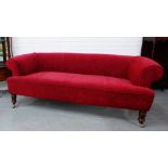 A red upholstered plush sofa with scroll arms and back on turned mahogany supports, 66 x 190cm