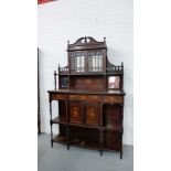 An Edwardian rosewood and inlaid display cabinet, the ledgeback with swan neck pediment over a