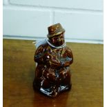 A Scottish Pottery treacle glazed Souter Johnnie money bank, 10cm high