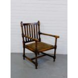 An oak framed open armchair with slip in seat, bobbin turned arms and legs, 90 x 61cm