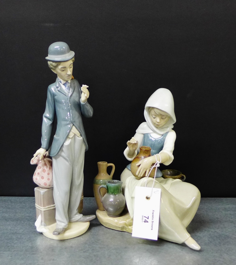 Two Lladro porcelain figures to include Charlie Chaplin (a/f) and a Girl with water jugs, tallest