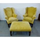 A pair of yellow floral fabric upholstered wing armchairs together with a matching footstool, 112
