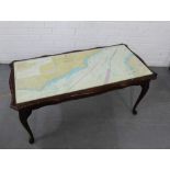 A glass topped coffee table with a Newhaven to Calais map to top, 46 x 97cm