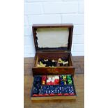 A mahogany box containing draughts, dominoes, chess men etc. (a lot)