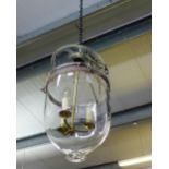 A glass domed light fitting containing a three branch fitting