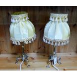 A pair of brass table lamp bases complete with yellow silk shades (2)