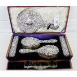 An Edwardian silver backed dressing table set, contained within a tan leather case, comprising