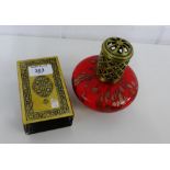 A brass engraved matchbox cover together with a red glass lamp (2)