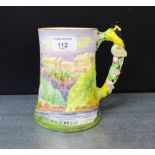 A Stirling Castle musical jug with floral moulded handle, 16cm high