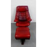 A red leather armchair on a swivel base together with matching footstool (2)