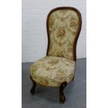 A floral upholstered mahogany framed nursing chair, terminating on brass castors, 104 x 50cm