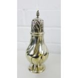 An Edwardian silver castor of spiralling baluster form, with flame finial and domed foot, bearing