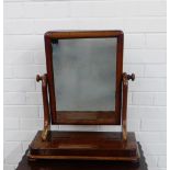 A 19th century mahogany dressing mirror, the rectangular plate on shaped side supports and