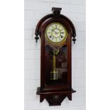 A mahogany wall clock, the arched top over an enamel chapter ring with Roman numerals, with glazed