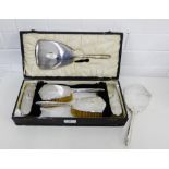 A Birmingham silver backed dressing table brush set comprising hand mirror, two hair brushes and two