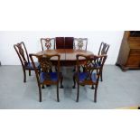 An oval mahogany dining table with two extra leaves on cabriole legs with claw and ball feet