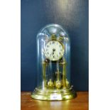 A brass Anniversary Clock under a glass dome, 30cm high