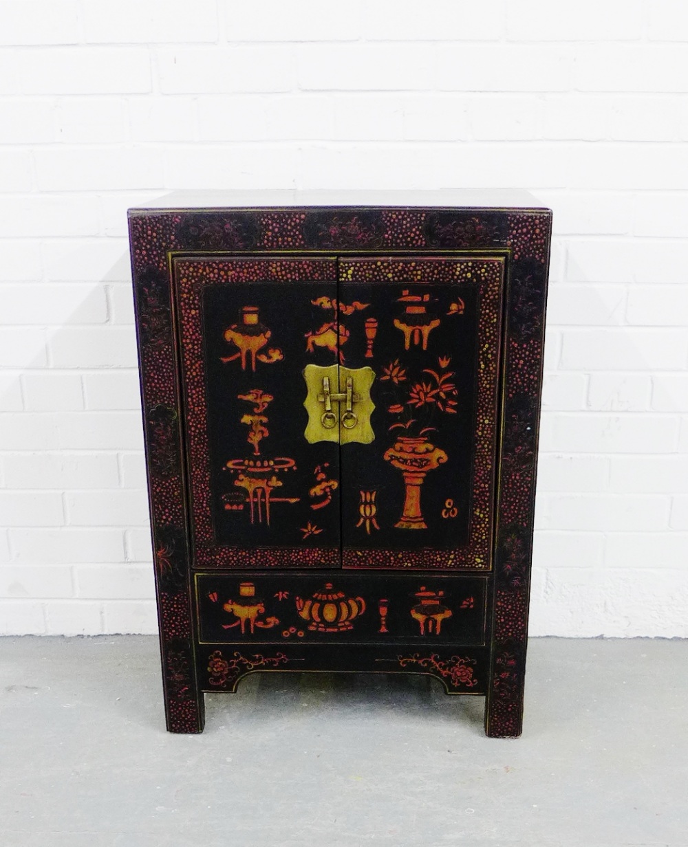 A black lacquered two door cabinet, painted with stylised Chinese motifs, raised on straight