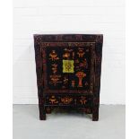 A black lacquered two door cabinet, painted with stylised Chinese motifs, raised on straight