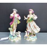 A pair of Derby style porcelain male and female figures, each dressed in 18th century costume with a