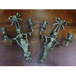 A pair of brass cherub twin branch wall appliques, 56cm long (2)