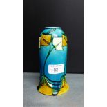 A Minton Limited art pottery vase with tube lined stylised flower decoration to a turquoise and