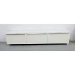 A contemporary white three door low storage unit with vertical long metal handles and feet, 38 x