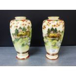 A pair of Japanese earthenware Satsuma style baluster vases painted with a landscape scene, 21cm